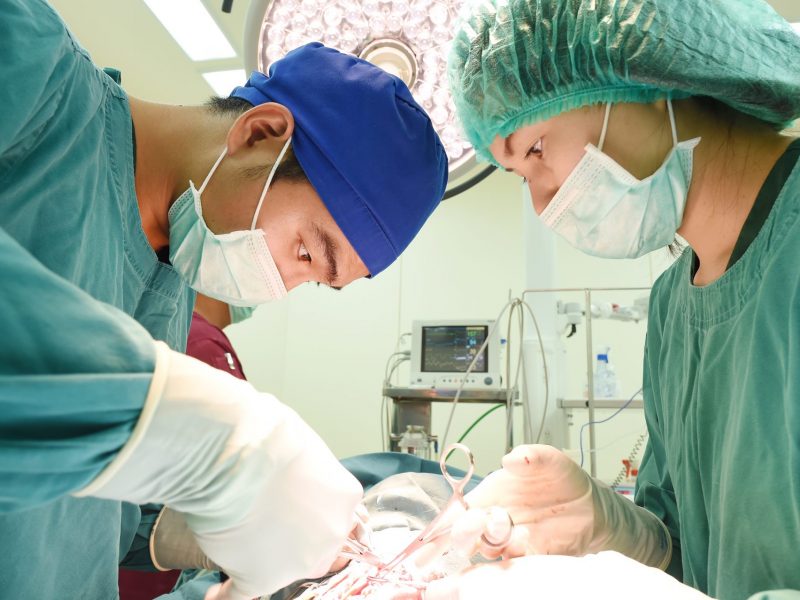 Médicos em remoção de tumores cutâneos benignos e malignos em sala de cirurgia